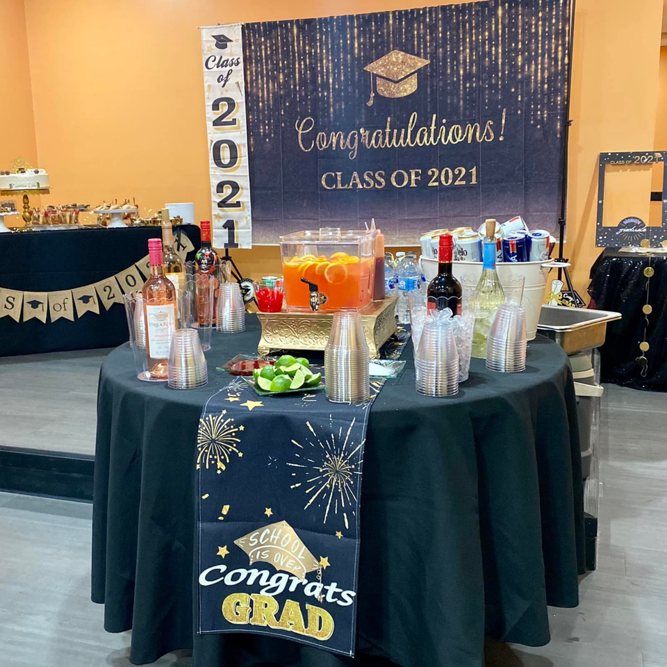 A graduation party setup with drinks, snacks, and "Class of 2021" decorations at Yak and Yeti Himalayan Cuisine.